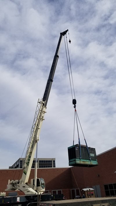 Crane lifting Cummins 250 kW Generator